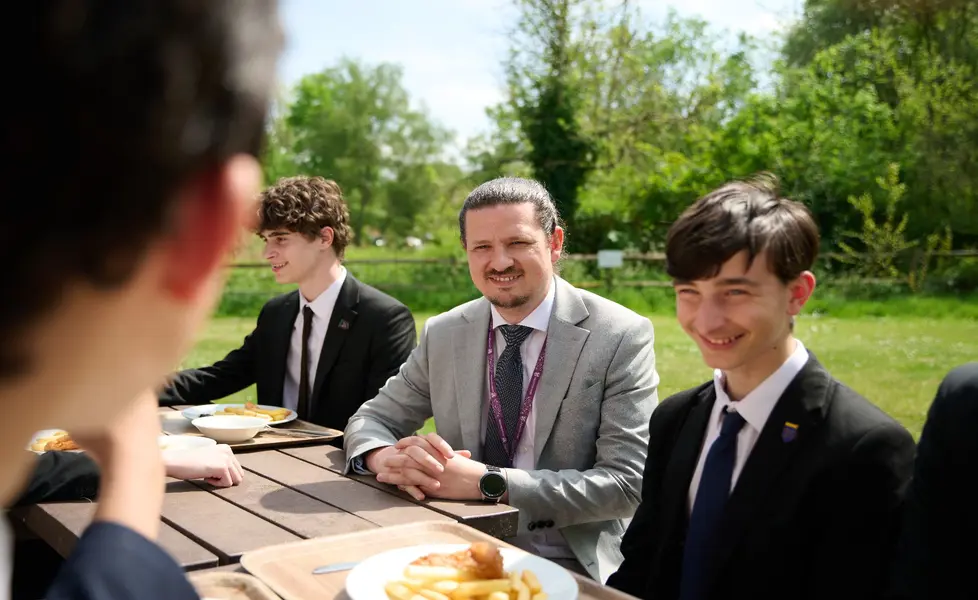 Teacher sat with students outside